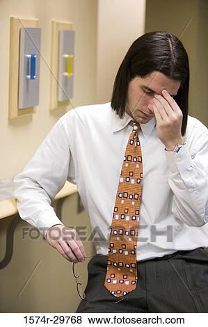 Stock Photo - Contemplative businessman in an office. Fotosearch