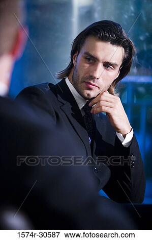 Contemplative businessman looking away with hand on chin View Large Photo Image Stock Photo - Contemplative businessman looking away with hand on chin. Fotosearch