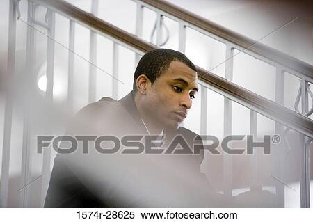 Contemplative businessman sitting on staircase View Large Photo Image Stock Photography - Contemplative businessman sitting on staircase. Fotosearch