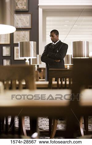 Stock Photo - Contemplative businessman standing in an office. Fotosearch