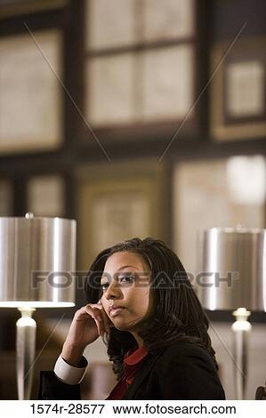 Stock Photo - Contemplative businesswoman in an office. Fotosearch