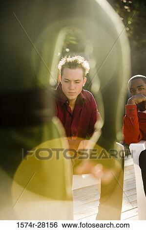 Contemplative men sitting on armchairs on wooden deck View Large Photo Image Stock Photograph - Contemplative men sitting on armchairs on wooden deck. Fotosearch