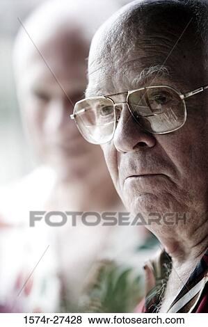 Contemplative senior man wearing glasses View Large Photo Image Stock Photo - Contemplative senior man wearing glasses. Fotosearch
