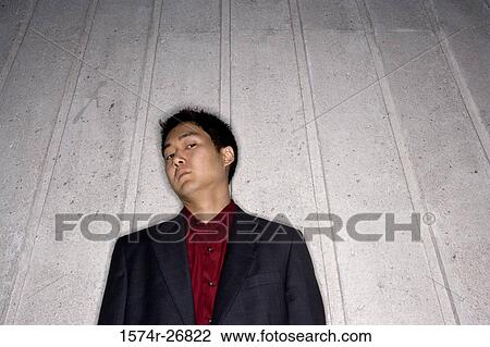 Contemplative young businessman leaning by wall View Large Photo Image Stock Image - Contemplative young businessman leaning by wall. Fotosearch