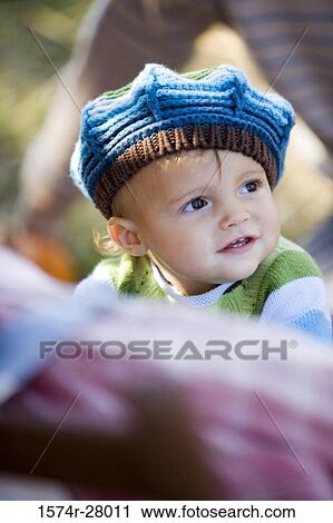 Cute boy in warm clothing looking away View Large Photo Image Stock Image - Cute boy in warm clothing looking away. Fotosearch