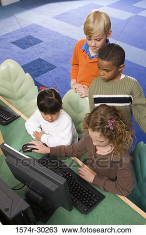 Elevated view of schoolboys and girls using computer in the library View Large Photo Image Stock Image - Elevated view of schoolboys and girls using computer in the library. Fotosearch