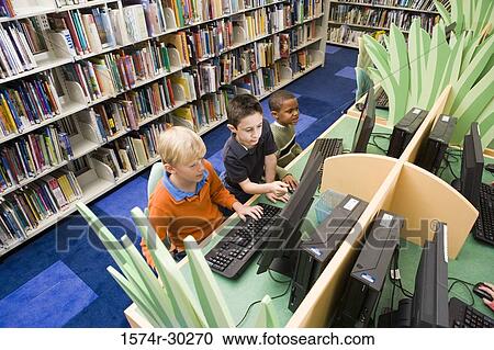 Elevated view of schoolboys using computer in the library View Large Photo Image Stock Image - Elevated view of schoolboys using computer in the library. Fotosearch