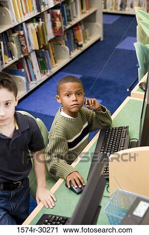 Elevated view of schoolboys using computer in the library View Large Photo Image Stock Image - Elevated view of schoolboys using computer in the library. Fotosearch