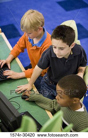 Elevated view of schoolboys using computer in the library View Large Photo Image Stock Image - Elevated view of schoolboys using computer in the library. Fotosearch