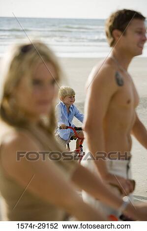 Family riding bicycle at the beach View Large Photo Image Stock Image - Family riding bicycle at the beach. Fotosearch
