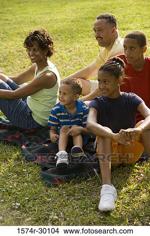 Family sitting on blanket at park View Large Photo Image Picture - Family sitting on blanket at park. Fotosearch