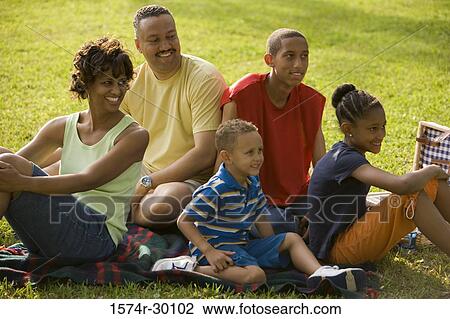 Family sitting on blanket at park View Large Photo Image Stock Image - Family sitting on blanket at park. Fotosearch