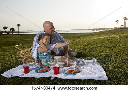 Father and daughter on a picnic at a park View Large Photo Image Picture - Father and daughter on a picnic at a park. Fotosearch