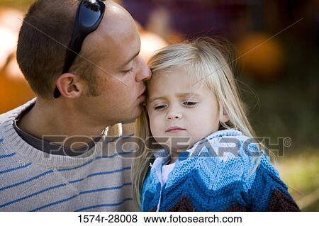 Father kissing head of his daughter View Large Photo Image Stock Photo - Father kissing head of his daughter. Fotosearch