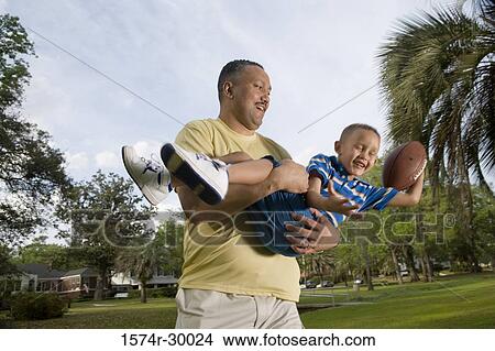 Father playing with his son at park View Large Photo Image Picture - Father playing with his son at park. Fotosearch
