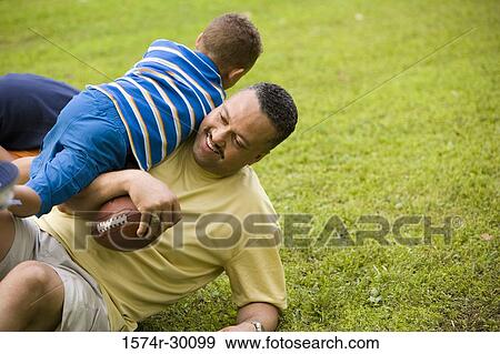 Father playing with his son at park View Large Photo Image Stock Photo - Father playing with his son at park. Fotosearch
