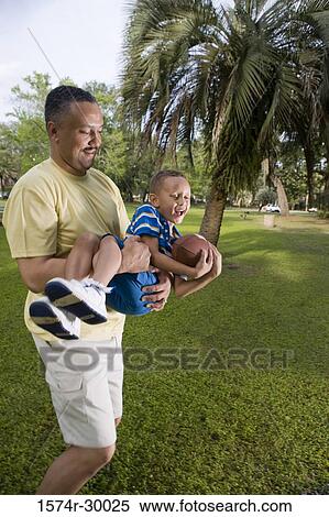 Father playing with his son at park View Large Photo Image Stock Photography - Father playing with his son at park. Fotosearch