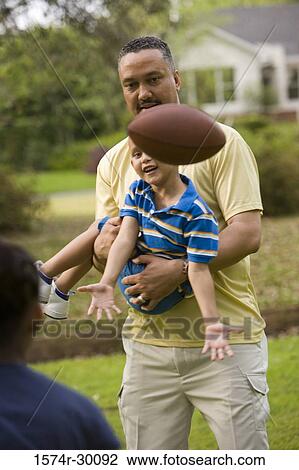 Father playing with their children at park View Large Photo Image Stock Image - Father playing with their children at park. Fotosearch