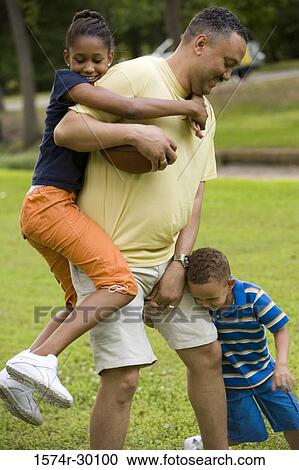 Father playing with their children at park View Large Photo Image Stock Image - Father playing with their children at park. Fotosearch