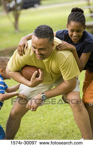 Father playing with their children at park View Large Photo Image Stock Photo - Father playing with their children at park. Fotosearch