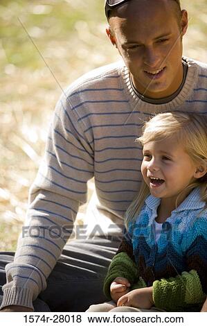 Father sitting with his smiling daughter View Large Photo Image Stock Photo - Father sitting with his smiling daughter. Fotosearch