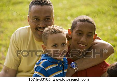 Father smiling with their children at park View Large Photo Image Stock Photography - Father smiling with their children at park. Fotosearch