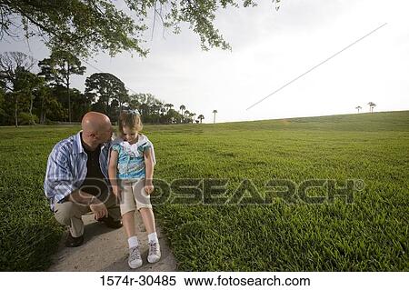 Father with daughter relaxing at a park View Large Photo Image Stock Photography - Father with daughter relaxing at a park. Fotosearch