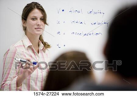 Female student standing in front of a white board in the classroom View Large Photo Image Picture - Female student standing in front of a white board in the classroom. Fotosearch