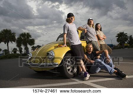 Friends by a car at the parking area View Large Photo Image Stock Image - Friends by a car at the parking area. Fotosearch