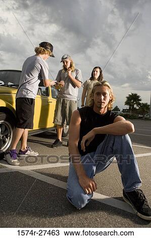 Friends by a car at the parking area View Large Photo Image Stock Image - Friends by a car at the parking area. Fotosearch