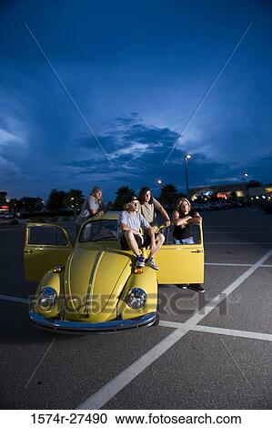 Friends by a car at the parking area View Large Photo Image Stock Image - Friends by a car at the parking area. Fotosearch