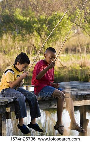Friends fishing with fishing rods by lake at forest View Large Photo Image Stock Photograph - Friends fishing with fishing rods by lake at forest. Fotosearch