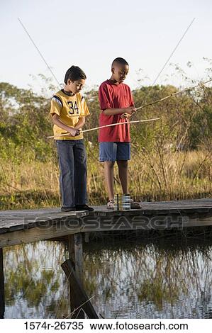 Friends fishing with fishing rods by lake at forest View Large Photo Image Stock Photography - Friends fishing with fishing rods by lake at forest. Fotosearch