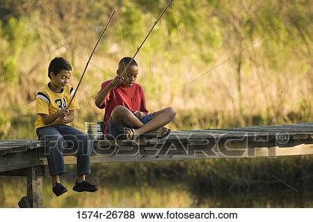 Friends fishing with fishing rods sitting on the jetty View Large Photo Image Stock Photo - Friends fishing with fishing rods sitting on the jetty. Fotosearch