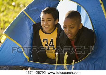 Friends looking through tent at forest View Large Photo Image Stock Image - Friends looking through tent at forest. Fotosearch