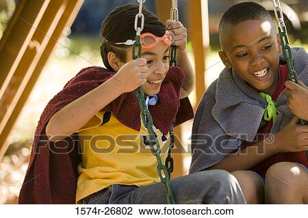 Friends playing with a swing View Large Photo Image Stock Image - Friends playing with a swing. Fotosearch