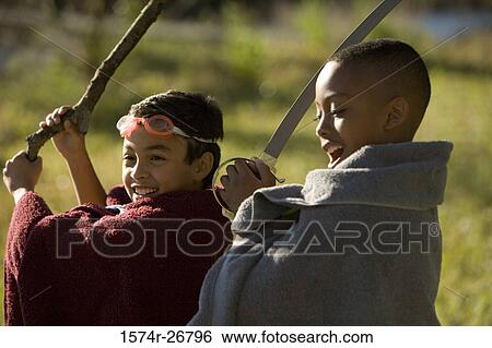 Friends playing with a sword and stick at forest View Large Photo Image Stock Photograph - Friends playing with a sword and stick at forest. Fotosearch