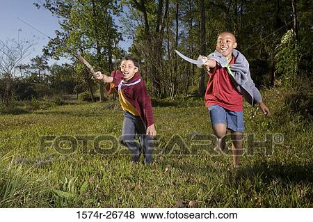 Friends playing with sword and stick at forest View Large Photo Image Stock Photo - Friends playing with sword and stick at forest. Fotosearch