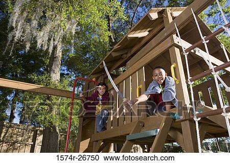 Friends playing with sword and stick in jungle gym at forest View Large Photo Image Stock Image - Friends playing with sword and stick in jungle gym at forest. Fotosearch