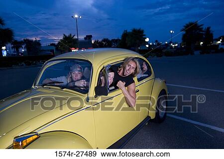Friends sitting in a car at the parking area View Large Photo Image Stock Photo - Friends sitting in a car at the parking area. Fotosearch