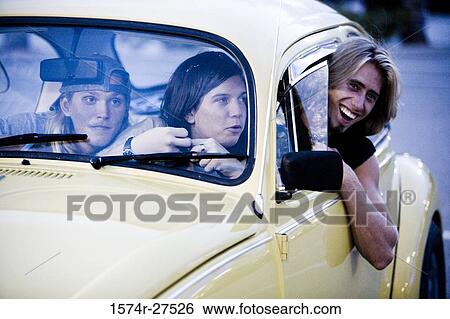 Friends sitting in a car at the parking area View Large Photo Image Stock Photograph - Friends sitting in a car at the parking area. Fotosearch