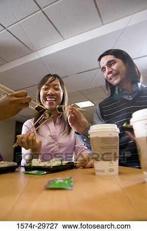 Friends sitting together and eating food View Large Photo Image Stock Photo - Friends sitting together and eating food. Fotosearch