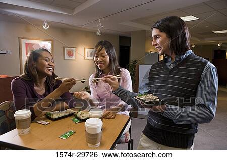 Friends sitting together and eating food View Large Photo Image Stock Photograph - Friends sitting together and eating food. Fotosearch