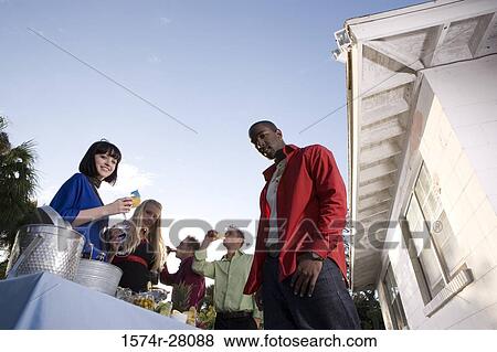 Friends standing with wineglass by house View Large Photo Image Stock Photo - Friends standing with wineglass by house. Fotosearch