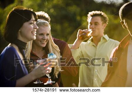 Friends with drinks outdoors View Large Photo Image Stock Image - Friends with drinks outdoors. Fotosearch