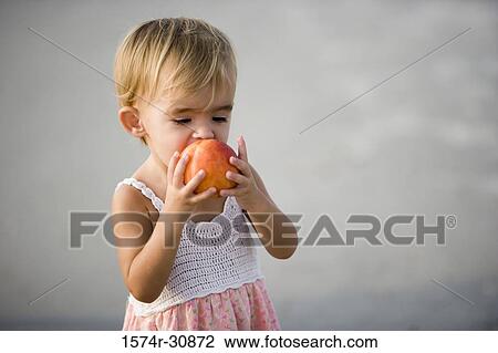 Girl eating fruit View Large Photo Image Stock Image - Girl eating fruit. Fotosearch