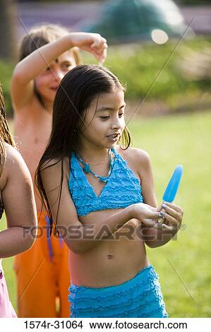 Girl holding flavored ice View Large Photo Image Picture - Girl holding flavored ice. Fotosearch