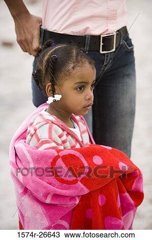 Stock Image - Girl in towel standing by her mother. Fotosearch