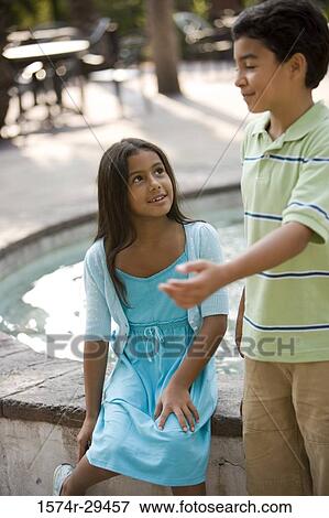 Girl sitting by boy View Large Photo Image Stock Photo - Girl sitting by boy. Fotosearch