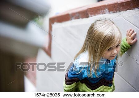 Girl standing by wall View Large Photo Image Stock Photography - Girl standing by wall. Fotosearch